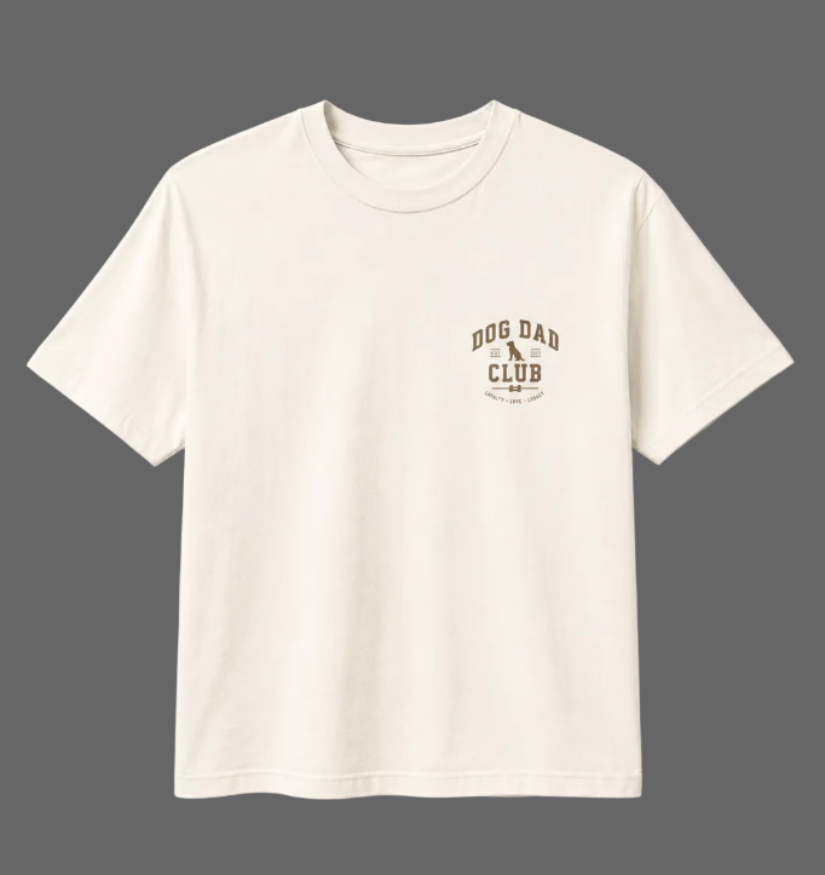 White t-shirt with 'Dog Dad Club' text on a light gray background